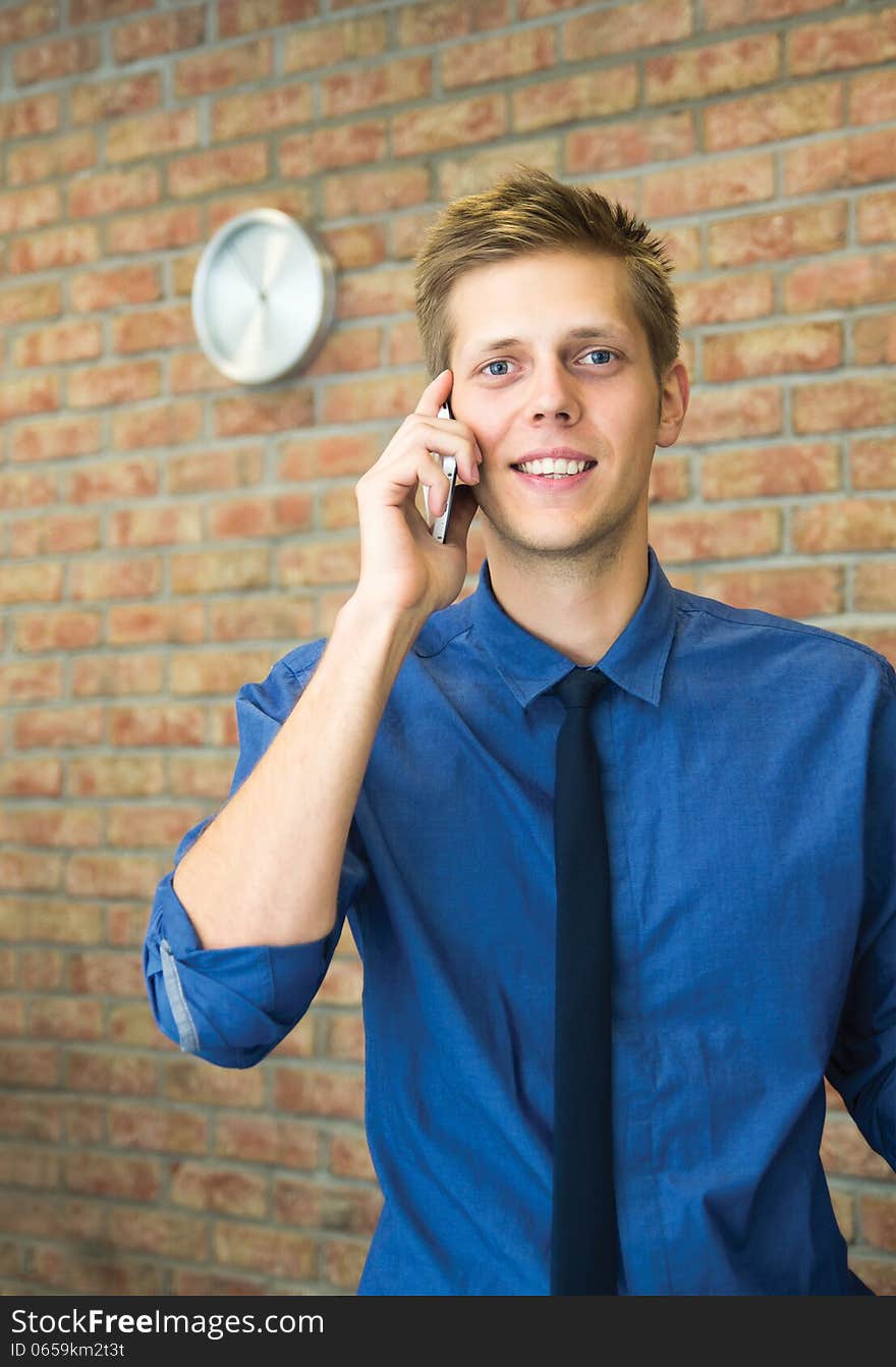 Young businessman talking on phone.