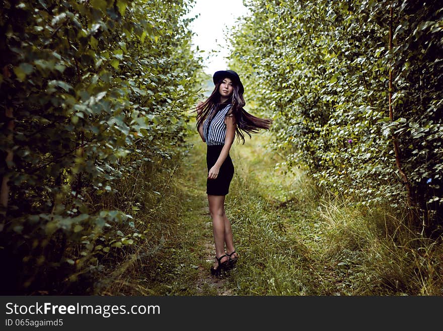 Fashionable Girl Waving Her Hair In Forest