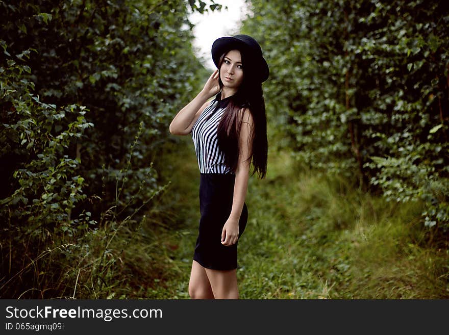 Fashionable Girl Standing In Forest