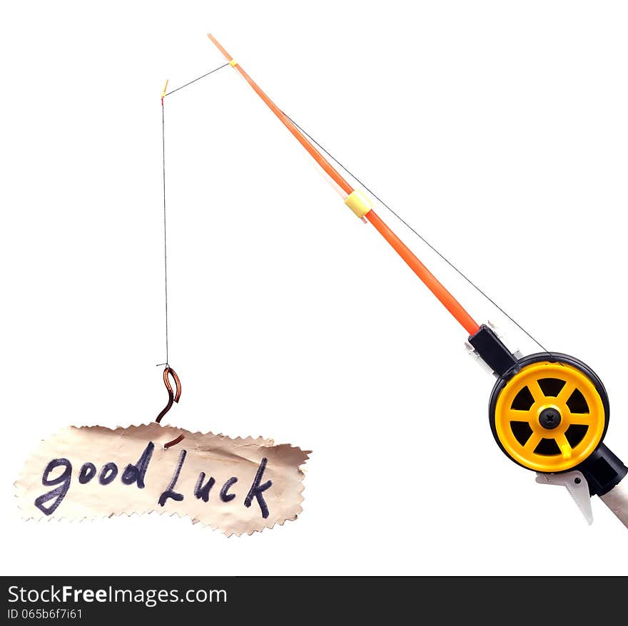 Fishing rod with a hook on wearing the piece of paper with the word luck