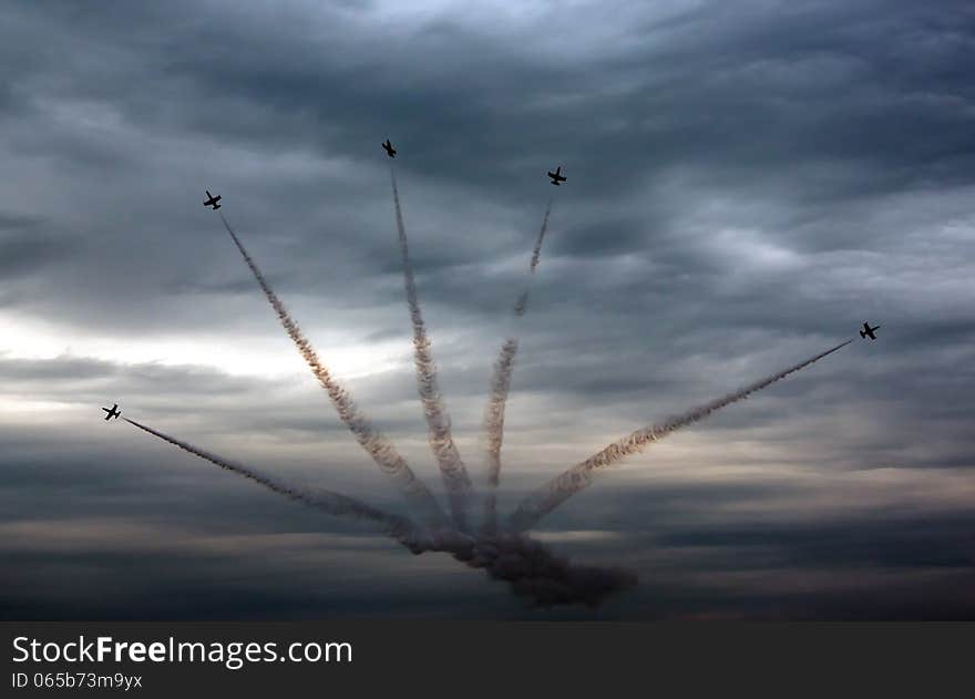 Aviation sports. five aircraft simultaneously fly against the stormy sky tightened with dark clouds. Aviation sports. five aircraft simultaneously fly against the stormy sky tightened with dark clouds