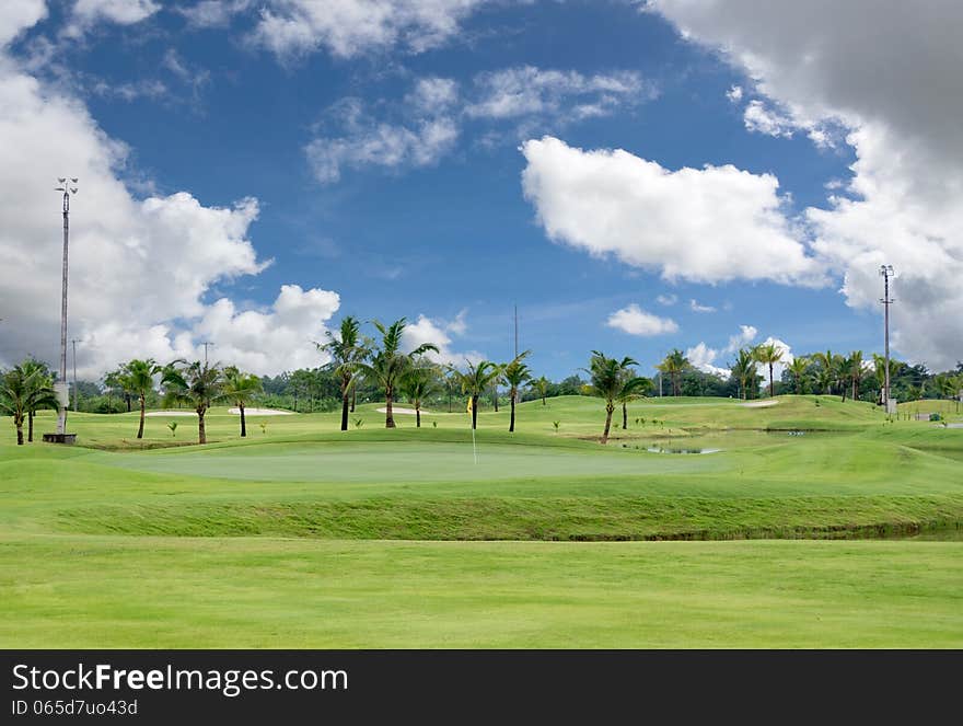 Landscape of a beautiful green golf field with bright blue sky. Landscape of a beautiful green golf field with bright blue sky