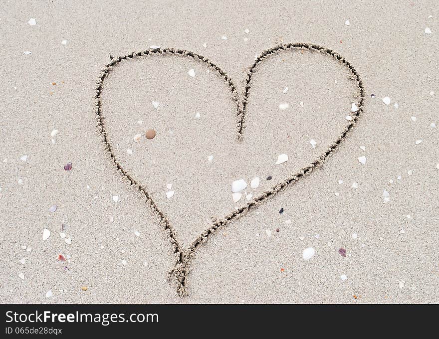 Heart shape drawn  in the sand. Heart shape drawn  in the sand