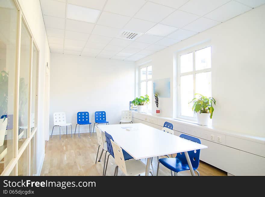 White small conference room with blue chairs. White small conference room with blue chairs