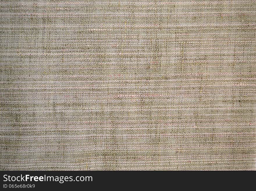 Piece of gray fabric with a coarse weave. Piece of gray fabric with a coarse weave