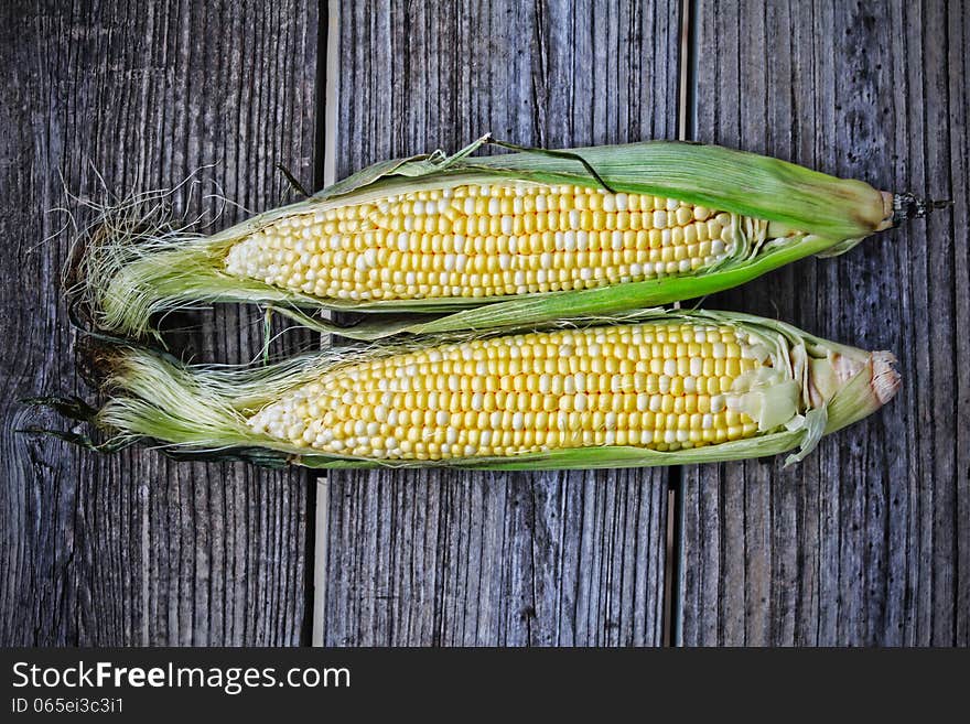 Corn cobs on a wooden table