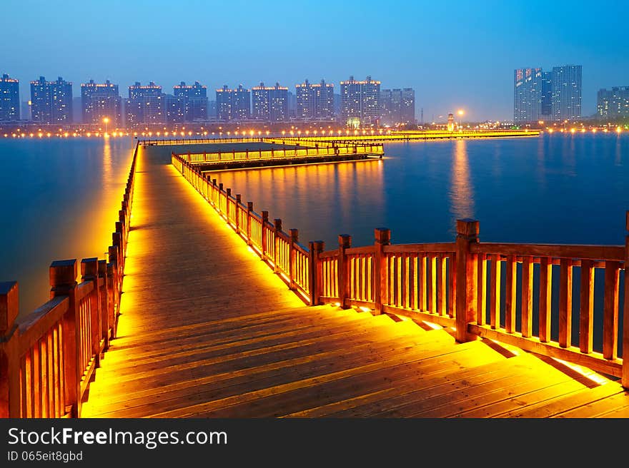 Golden brown wooden footway in night