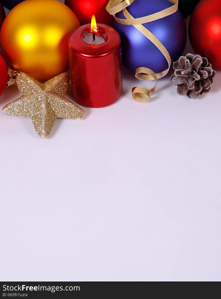 Red candle with the baubles and cones. Red candle with the baubles and cones