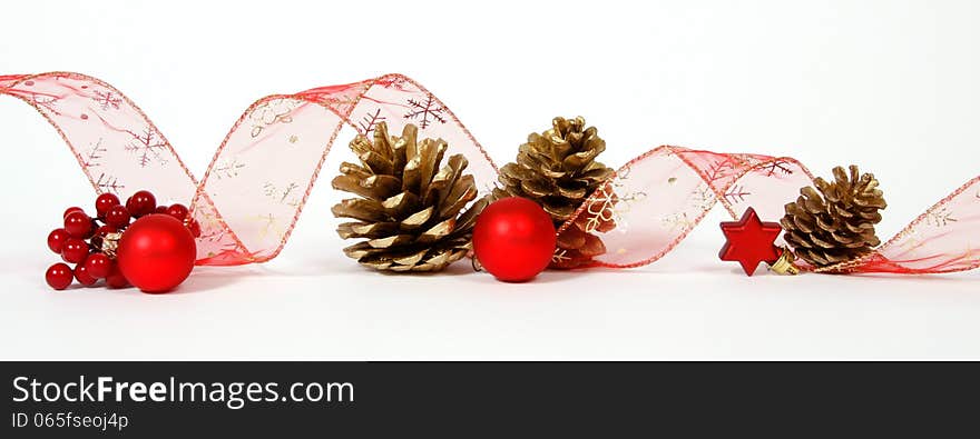 Baubles and cones with the ribbon on the white background. Baubles and cones with the ribbon on the white background