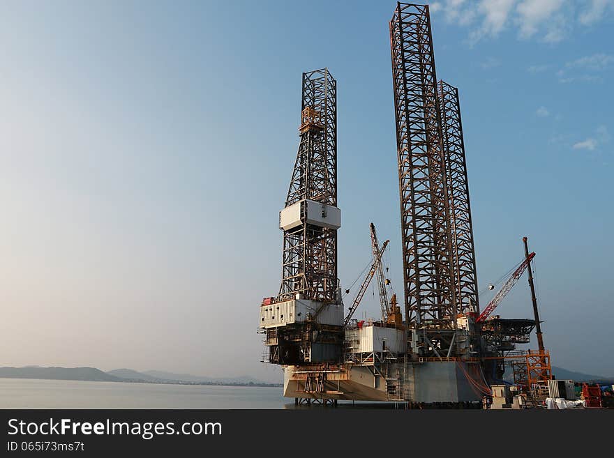 Jack up oil drilling rig in the shipyard at evening time