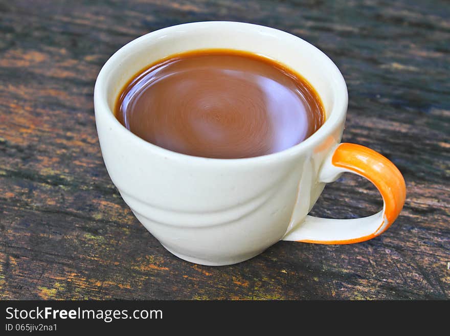 Hot coffee in white cup on a wooden table, During leisure time