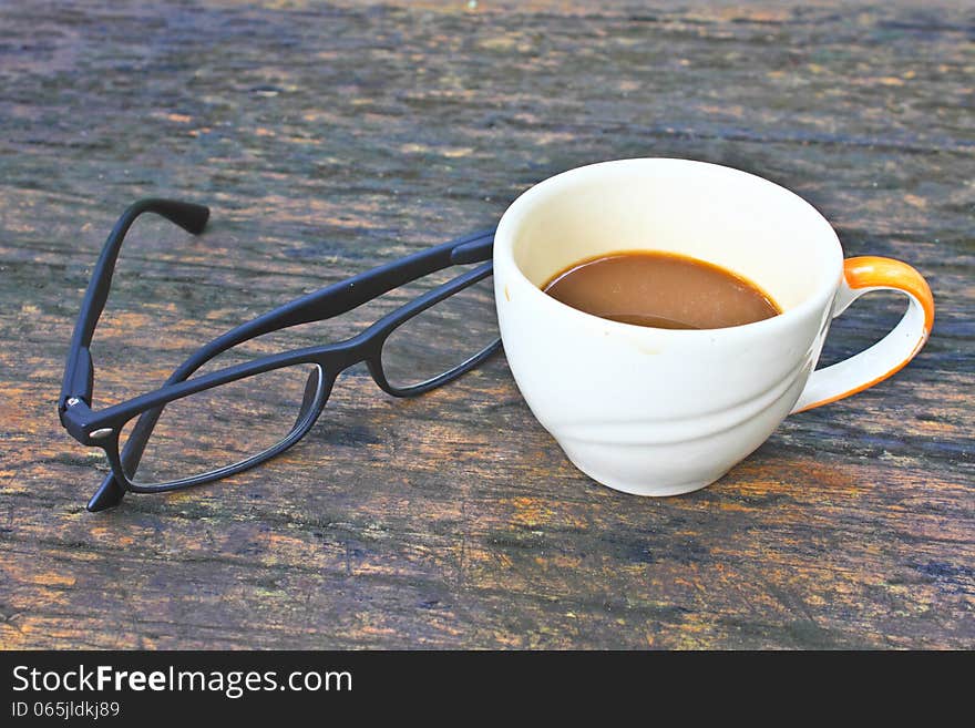 Hot coffee in white cup on a wooden table