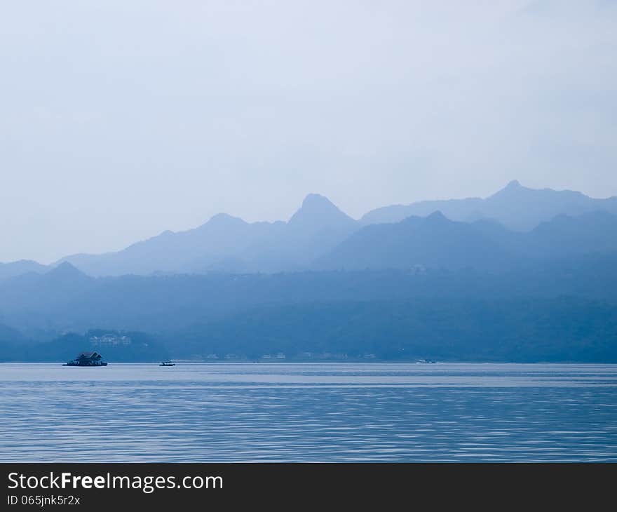 Landscape with blue mountains near lake in Thailand