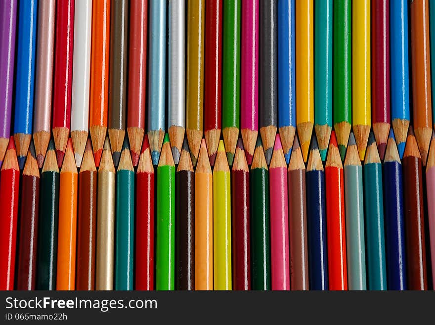 Rows of colorful wooden pencil crayons. Rows of colorful wooden pencil crayons