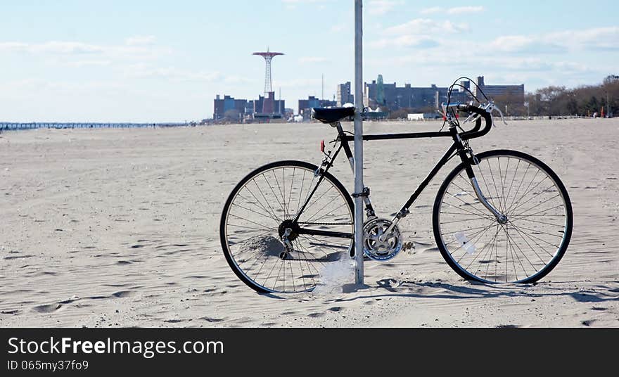 Rare situation with one bicycle on the beach of ocean view area ,sand was covering the part of wheel. Rare situation with one bicycle on the beach of ocean view area ,sand was covering the part of wheel