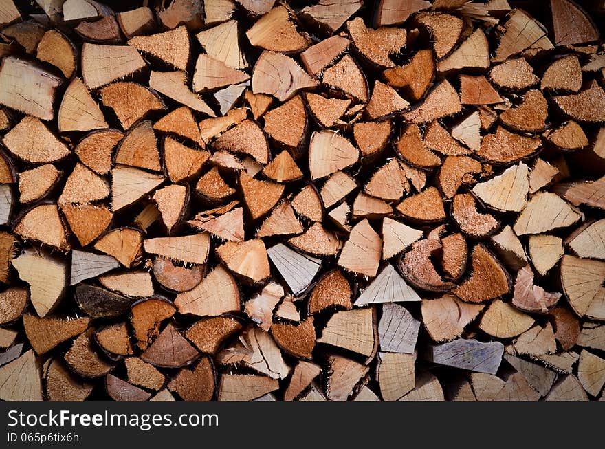 Background Texture Of Stacked Split Wood For Fire. Background Texture Of Stacked Split Wood For Fire