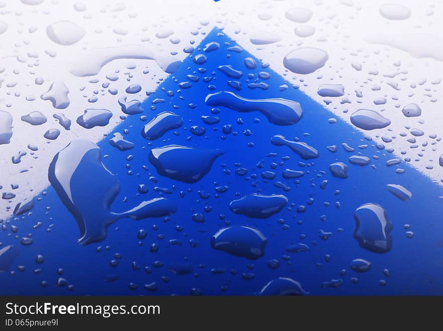 Close up image of water drops on blue surface. Close up image of water drops on blue surface