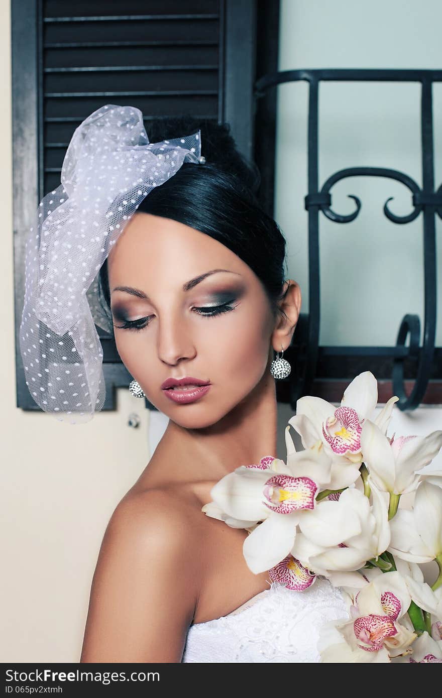 Beautiful brunette woman as bride with flowers