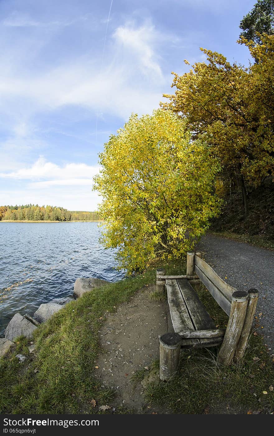 Sitting by a lake in autumn colors.