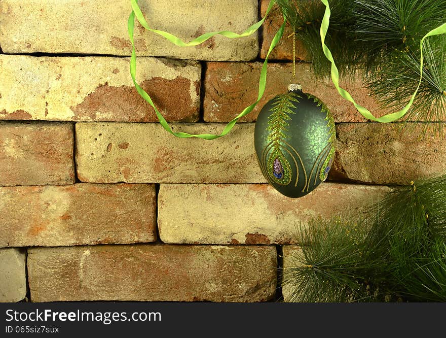 Green bauble on conifer branch