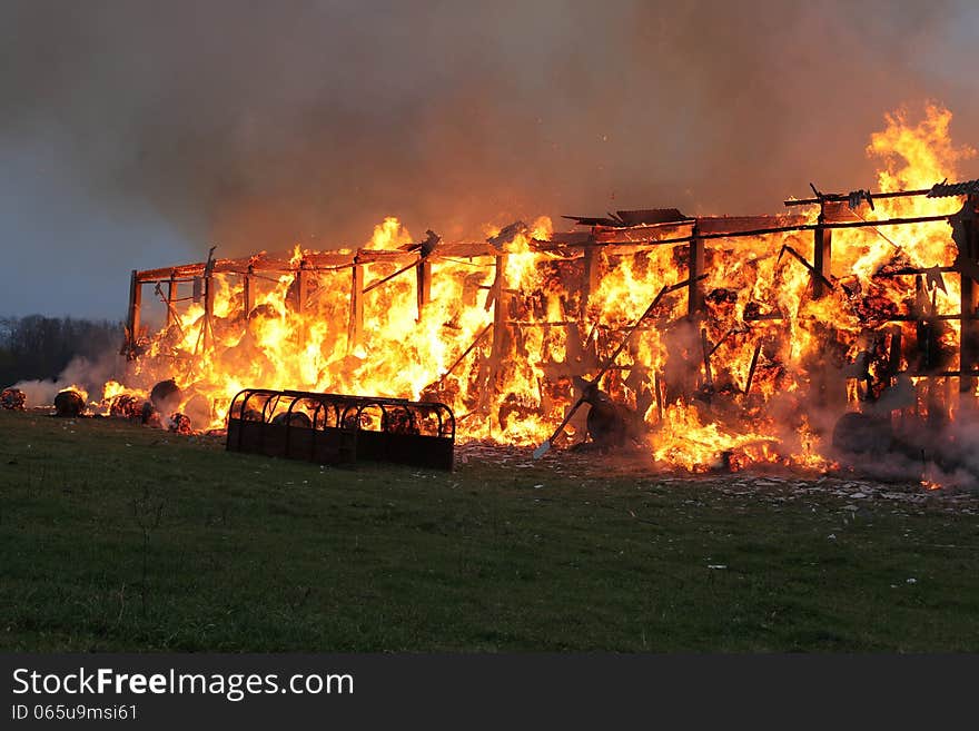 Burning farm building with hay