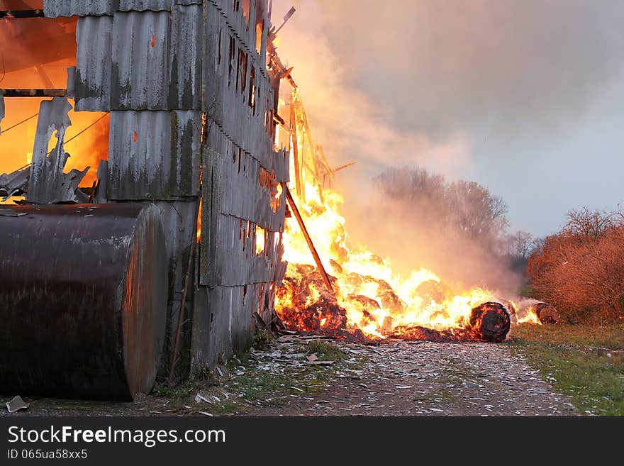 Burning farm building with hay