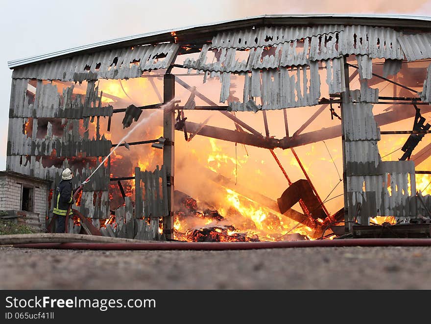 Burning farm building with hay