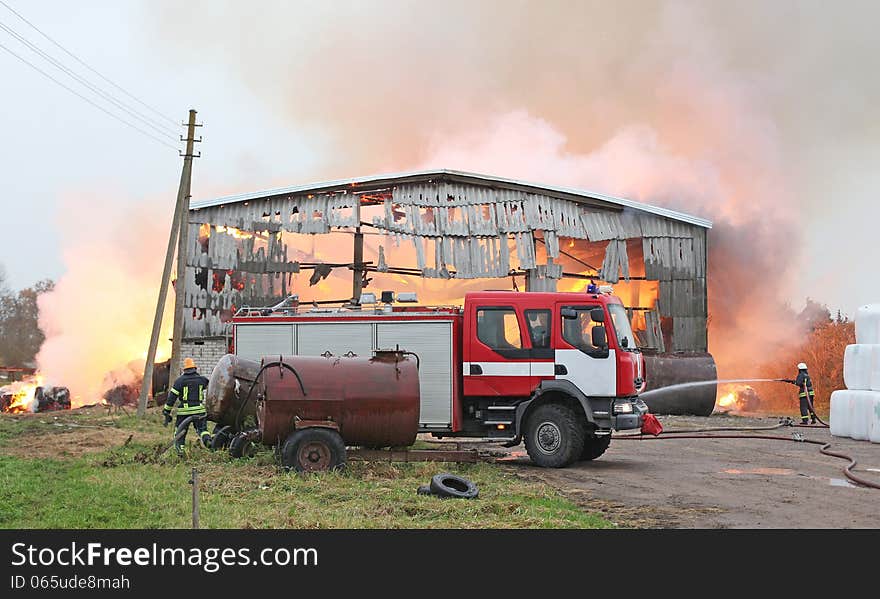 Burning farm building with hay