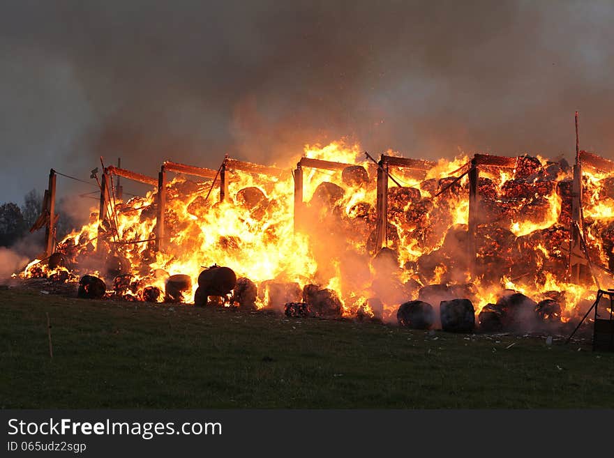 Burning farm building with hay