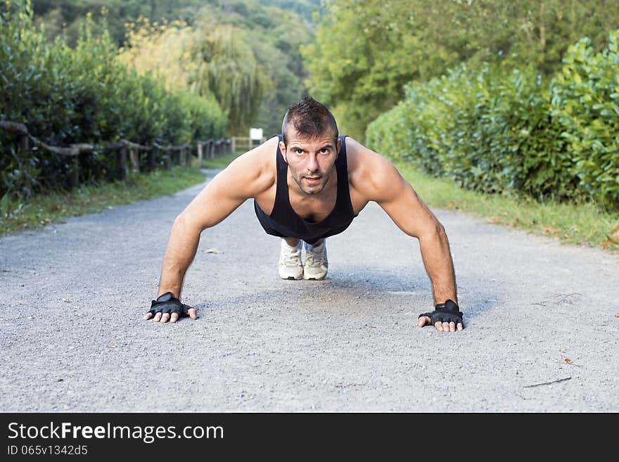 Muscular Man Doing Pushup In The Park.