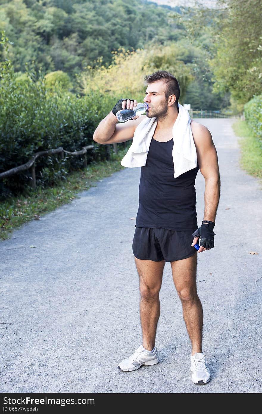 Athletic Man With Water Bottle After His Exercising Outdoor.