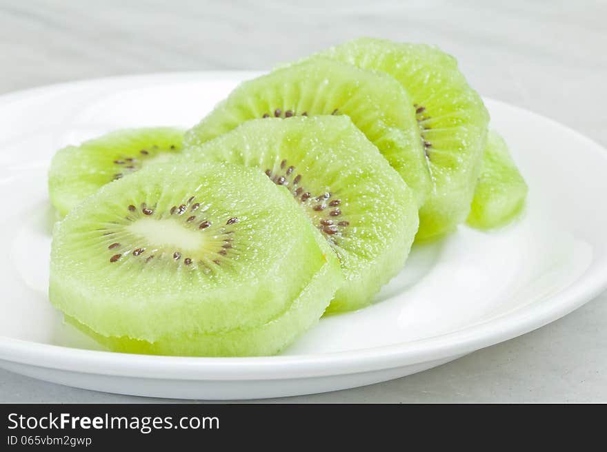 Kiwi fruits on white plate