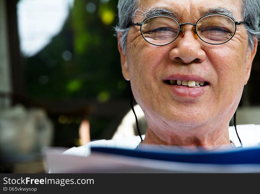 Portrait of smiling senior man with book