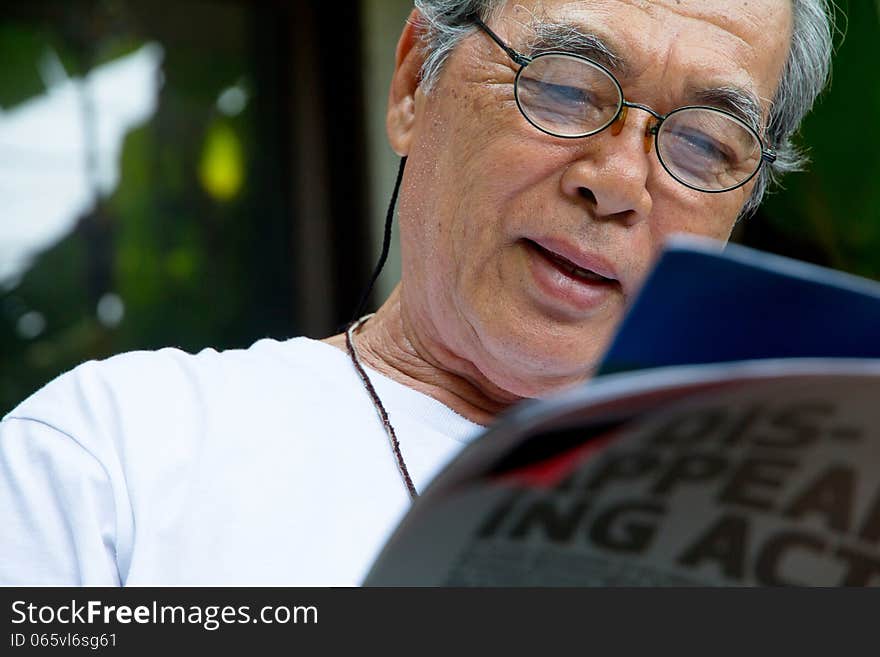 Portrait of smiling senior man with book