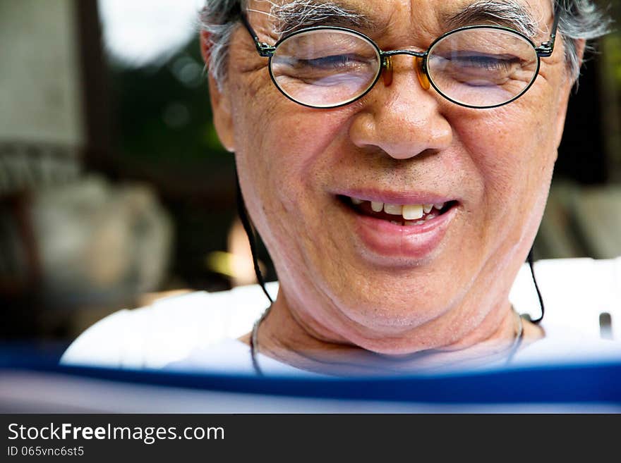 Portrait Of Smiling Senior Man With Book