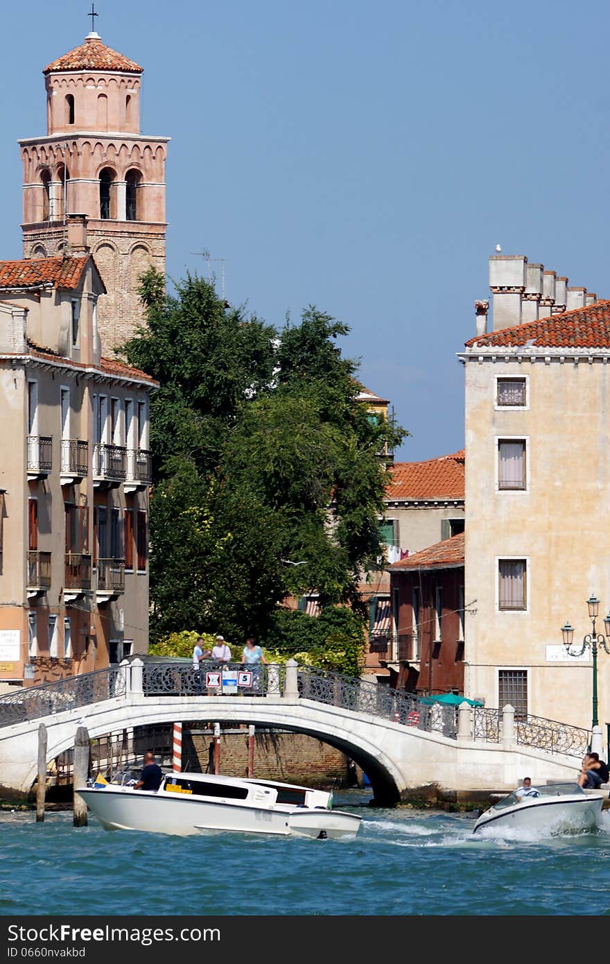 Picturesque Venetian Canals With Motor Boats And Bridge In Venic