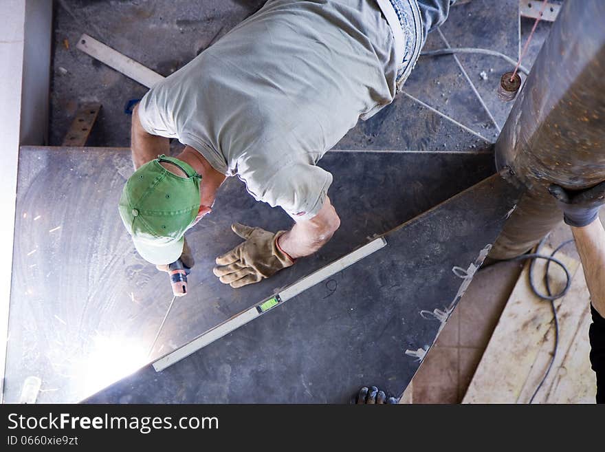 Construction worker welding at a building site