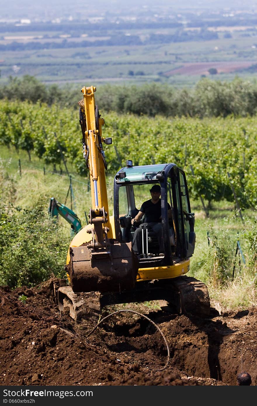 Costruction worker with a means of excavation at work. Costruction worker with a means of excavation at work