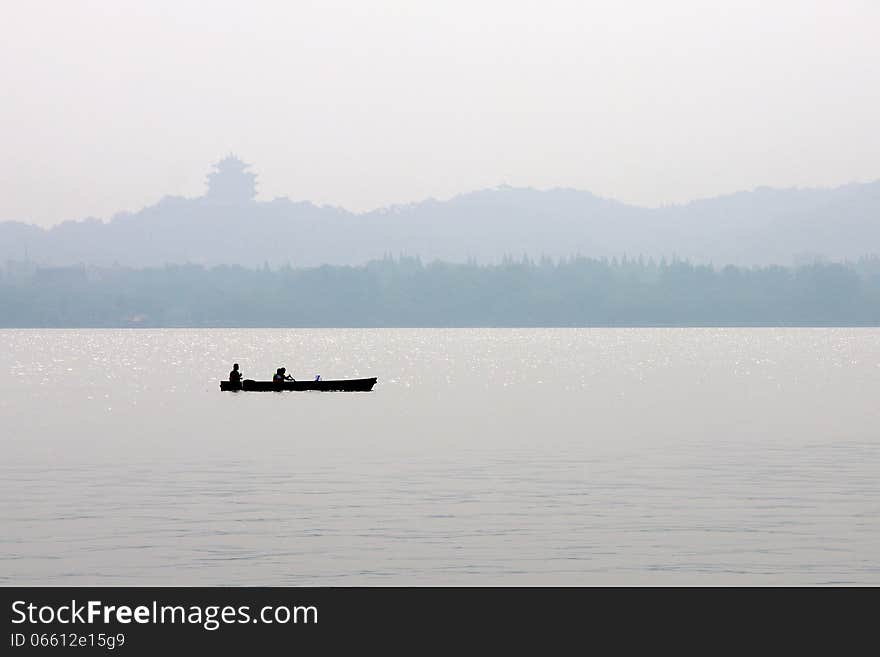 A boat is floating in xihu lake. A boat is floating in xihu lake