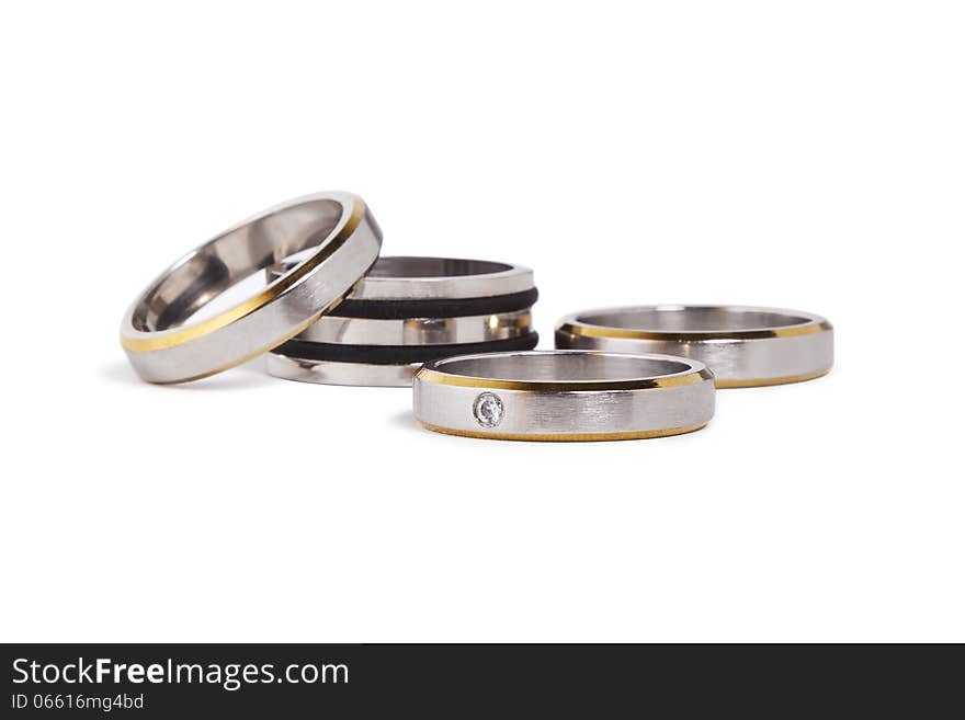 Stainless steel rings with silver and gold inlay. On isolated white background