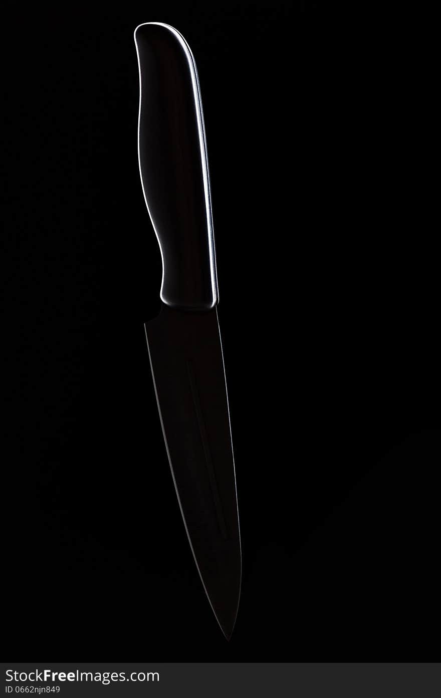 Kitchen knife on a black background