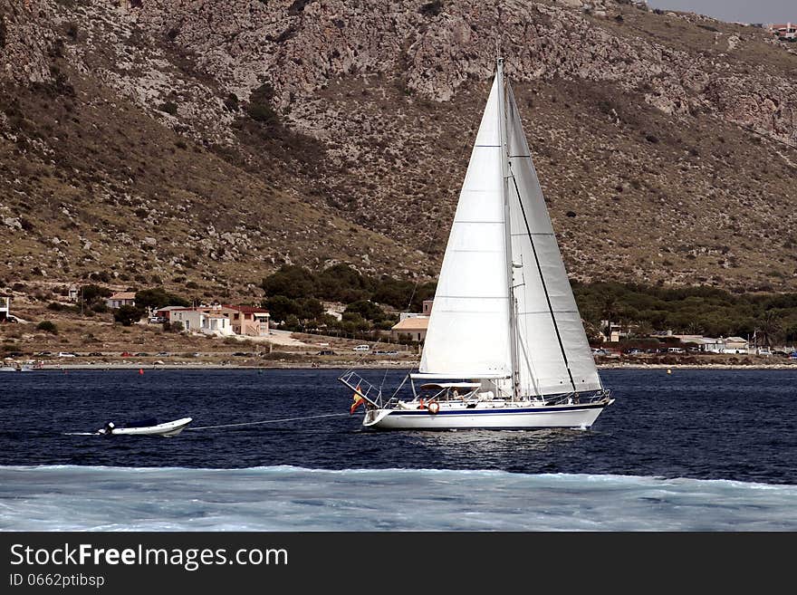 Sloop sailing close to Alicante coast. Sloop sailing close to Alicante coast