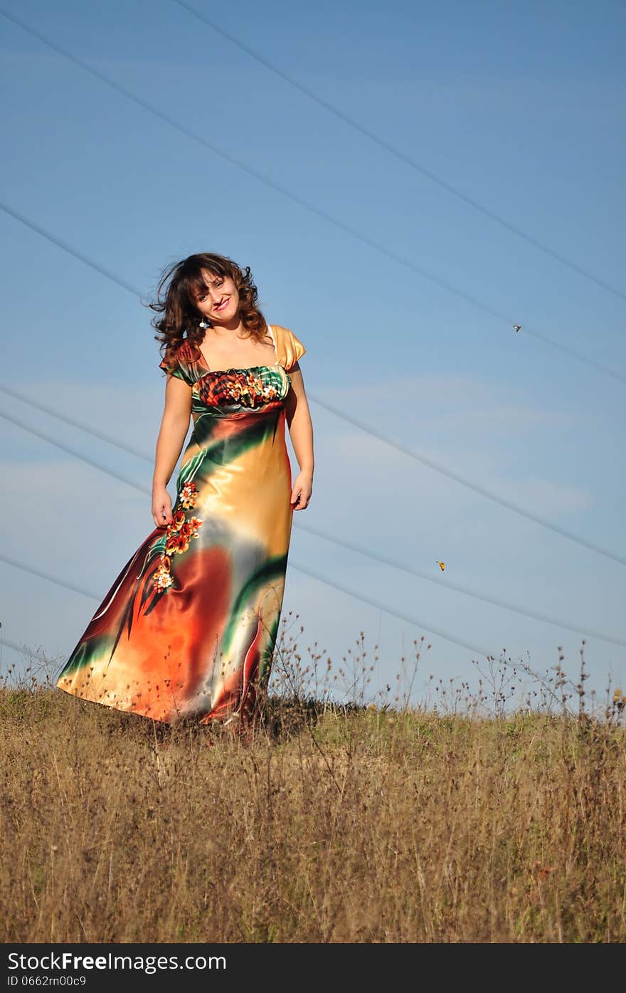 Woman in dress enjoying the sun. Woman in dress enjoying the sun.