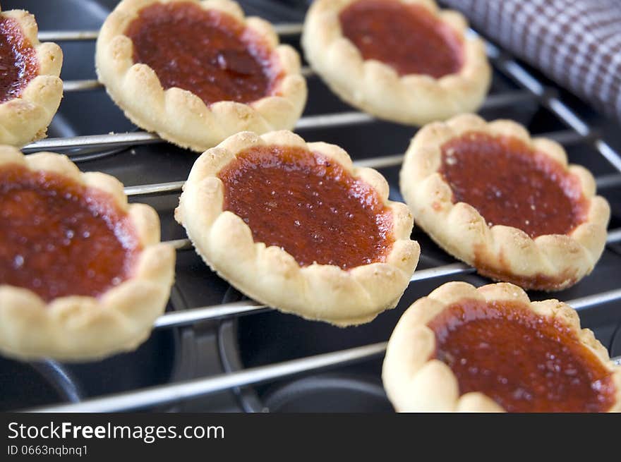 Close up cookies with red jam on tray