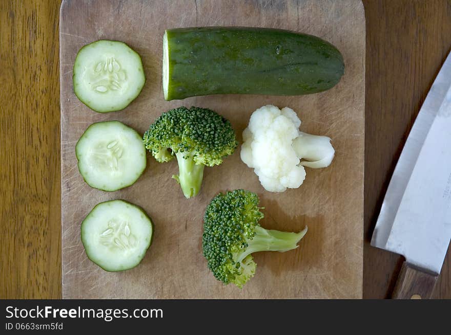 Green vegeatbles on wooden board