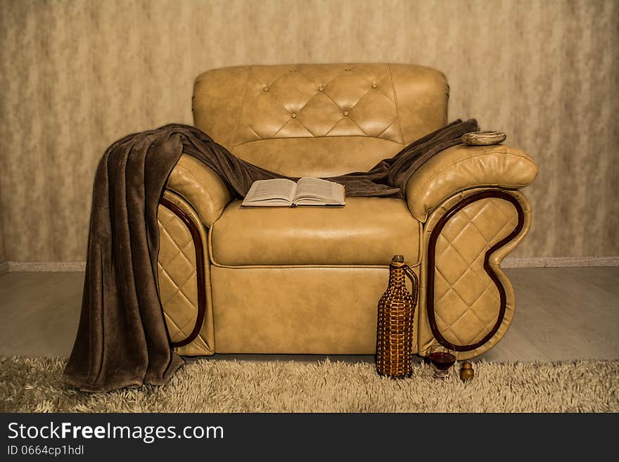 Comfortable chair for home entertainment, books, wine and an ashtray