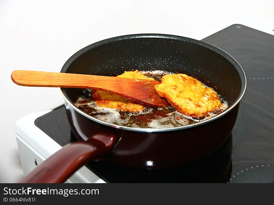 Wooden spoon fester steak in the pan. Wooden spoon fester steak in the pan