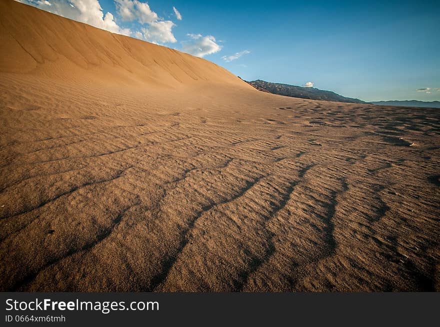 Death Valley sand dune looks like a big wave. Death Valley sand dune looks like a big wave