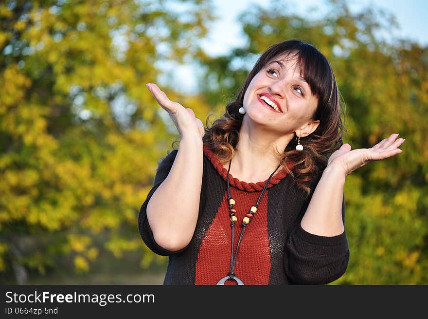 Woman laughing in park during summer. Happy smiling beautiful young woman outside in summer dress.