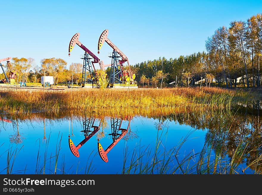 The pumping unit inverted reflection in water